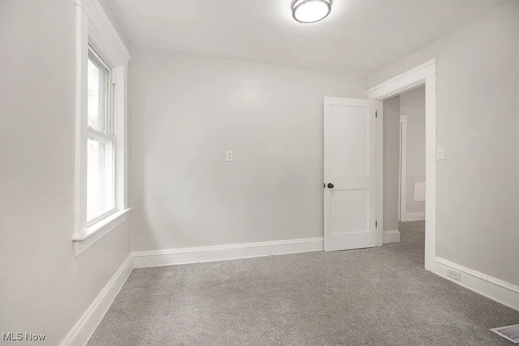 Unfurnished room featuring light carpet and​​‌​​​​‌​​‌‌​‌‌​​​‌‌​‌​‌​‌​​​‌​​ baseboards