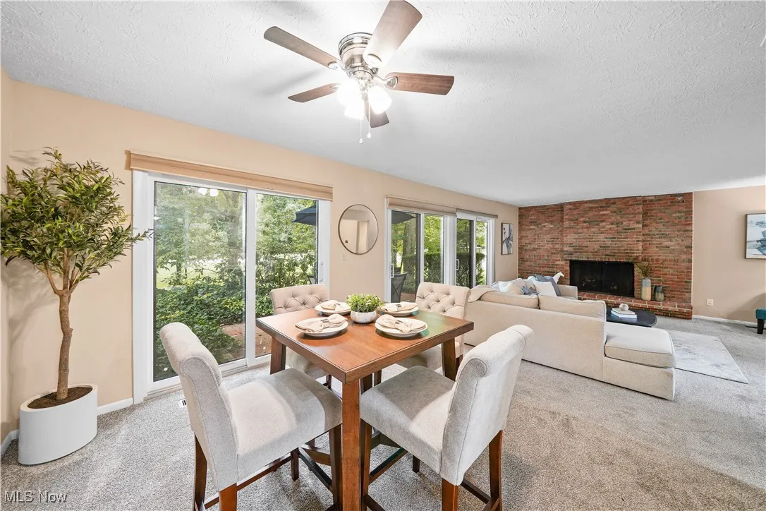 dedicated dining room with views of the back yard and fireplace.