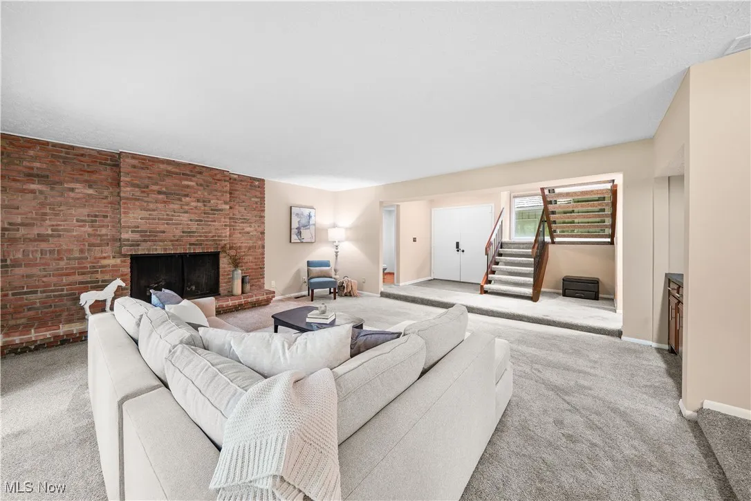 Entry way and great room with large brick gas fireplace.