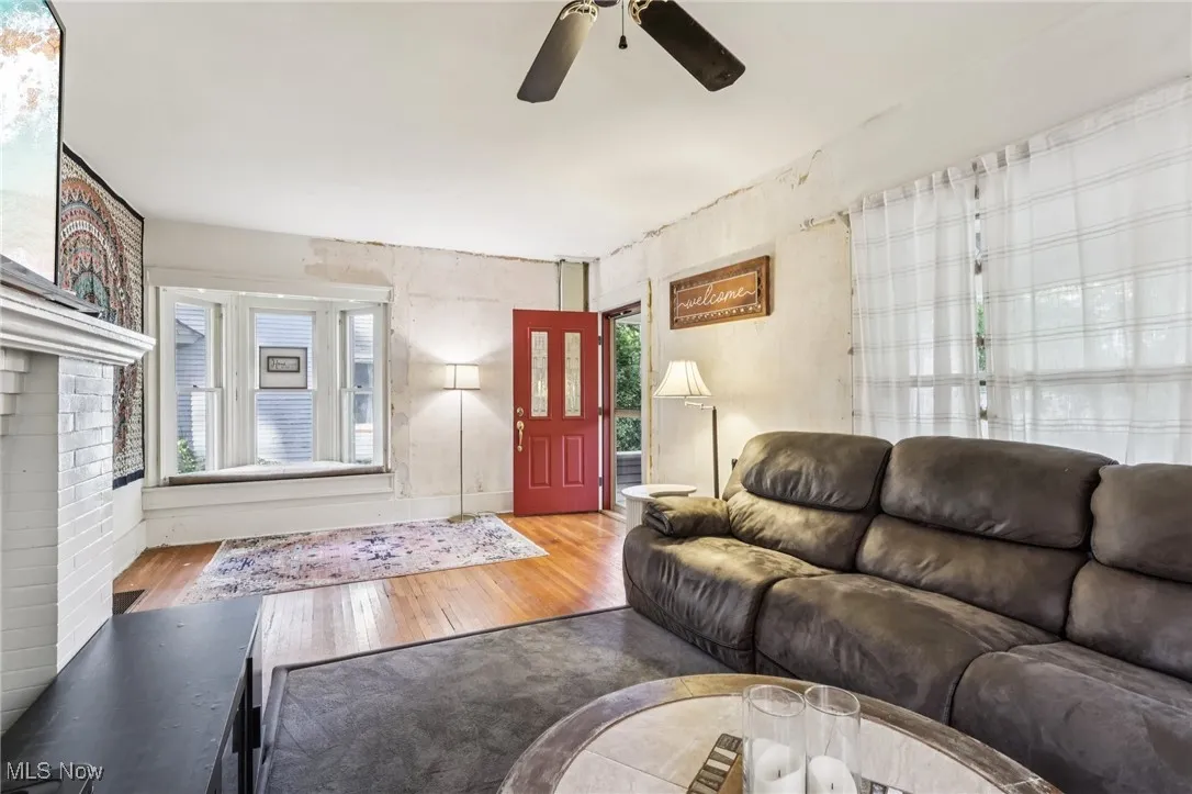 Living room featuring wood finished floors and a ceiling fan
