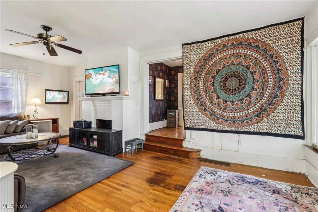 Living room with wood finished floors and a ceiling fan
