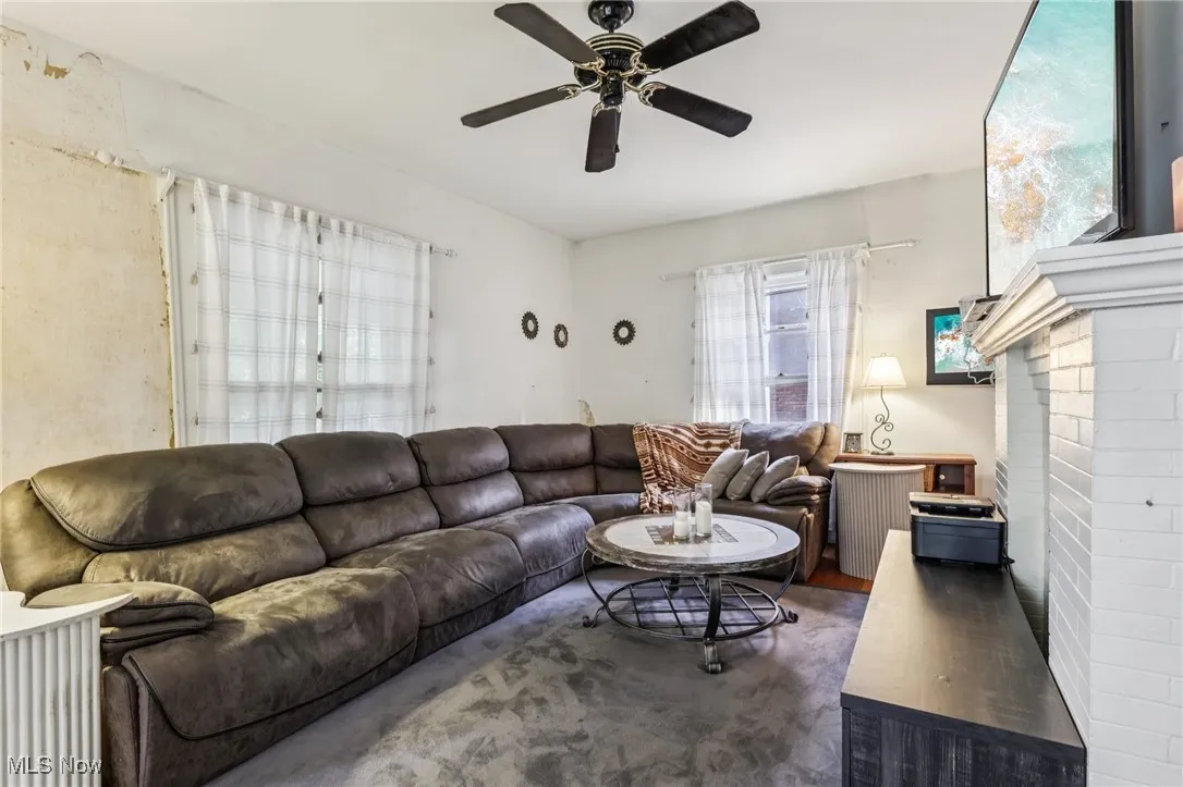 Living room featuring wood finished floors and a ceiling fan