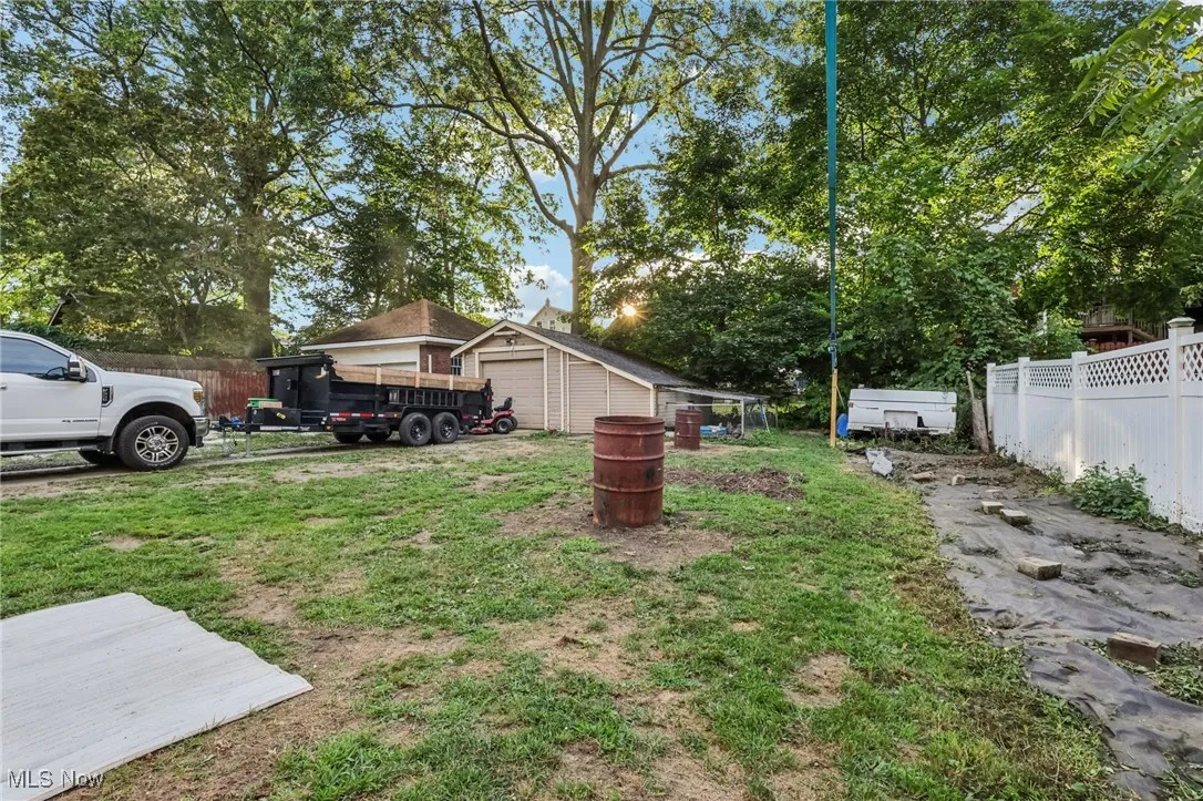 View of yard with an outbuilding and a garage