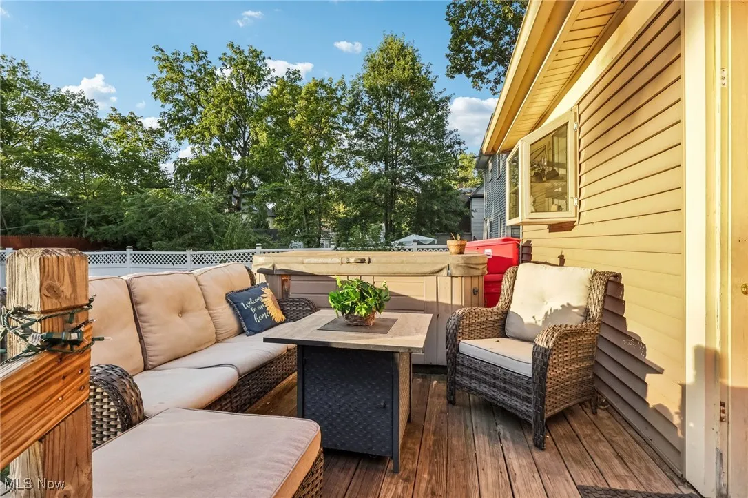 Deck featuring an outdoor hangout area and view of wooded area