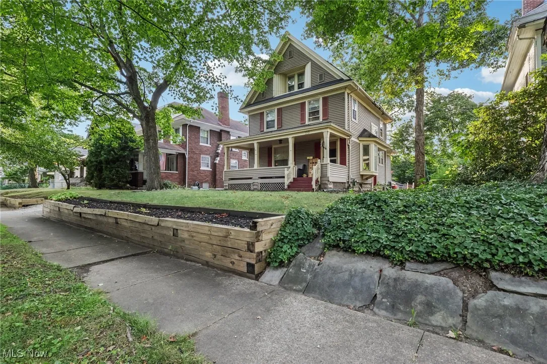 Traditional style home featuring a porch and a front yard