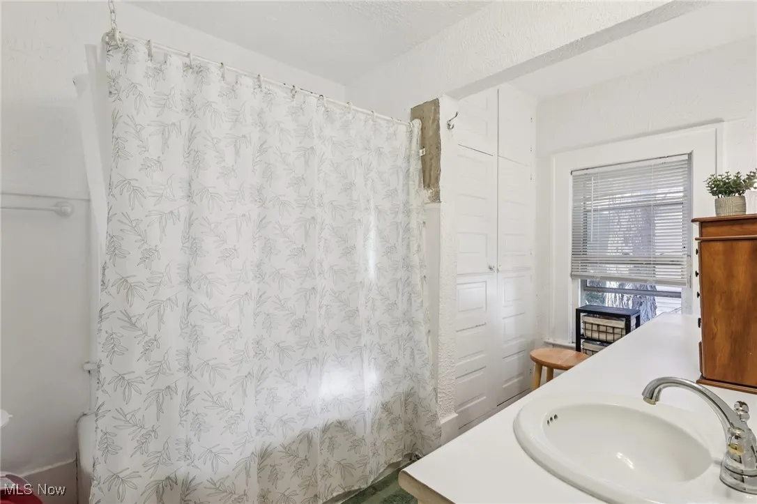 Full bath featuring vanity and shower / tub combo