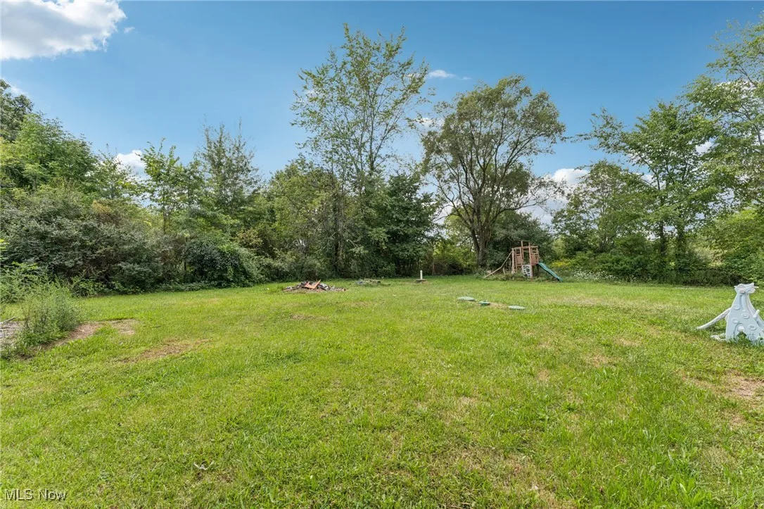View of grassy yard with a playground