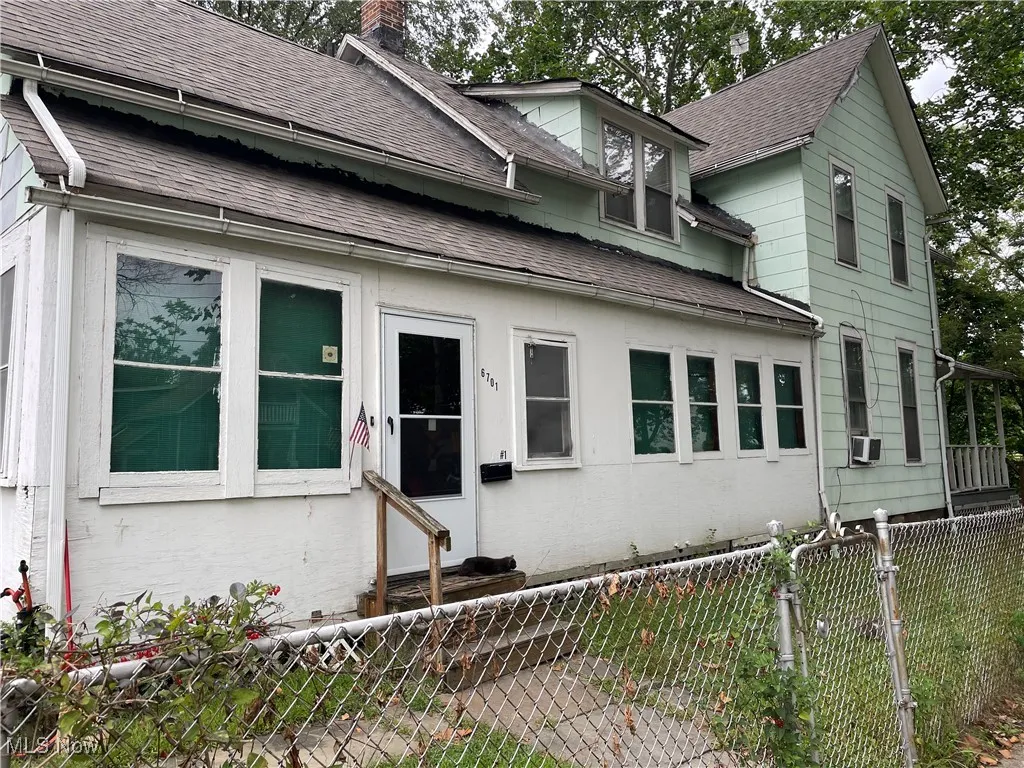 View of front of house with a chimney, a shingled roof, and entry steps