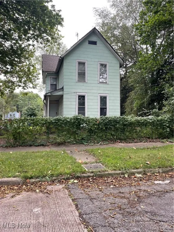 View of front of house with a shingled roof