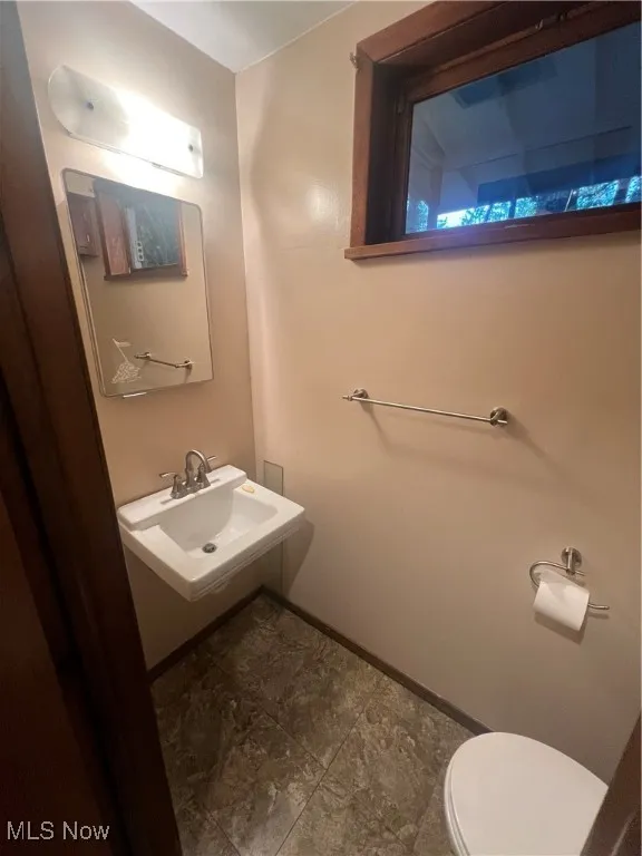 Half bathroom featuring a sink and toilet