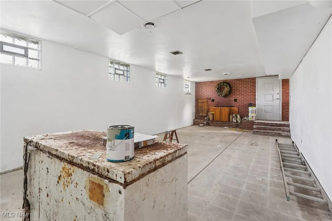 Bar area featuring unfinished concrete floors and brick wall