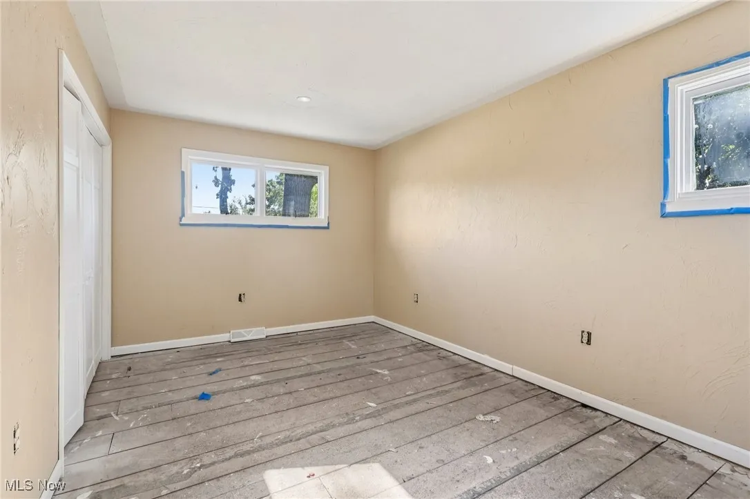 Unfurnished bedroom with hardwood / wood-style floors and a closet