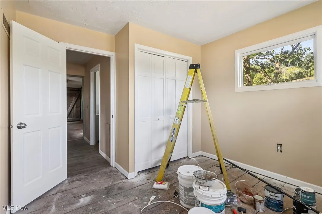Unfurnished bedroom featuring a closet and wood finished floors