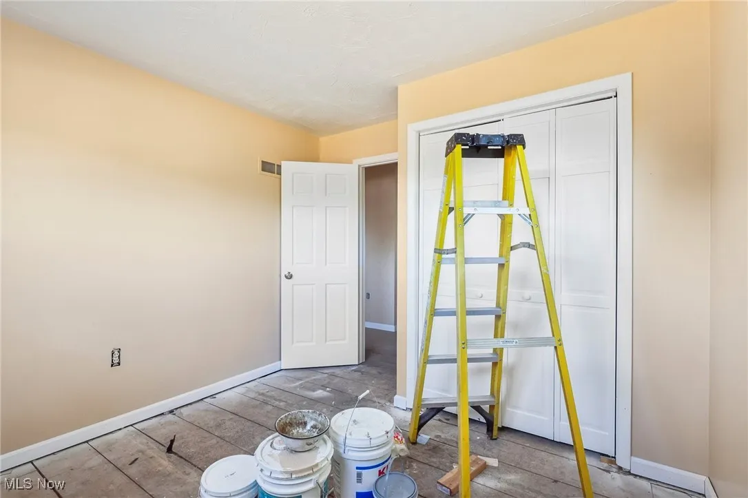 Unfurnished bedroom with a closet and wood finished floors