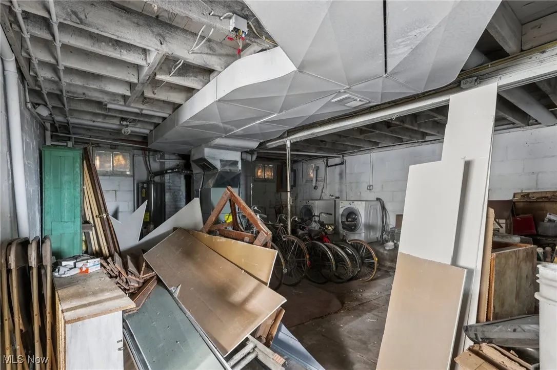 Unfinished basement with washer / clothes dryer