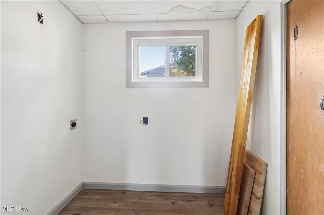 Washroom featuring dark wood finished floors and electric dryer hookup
