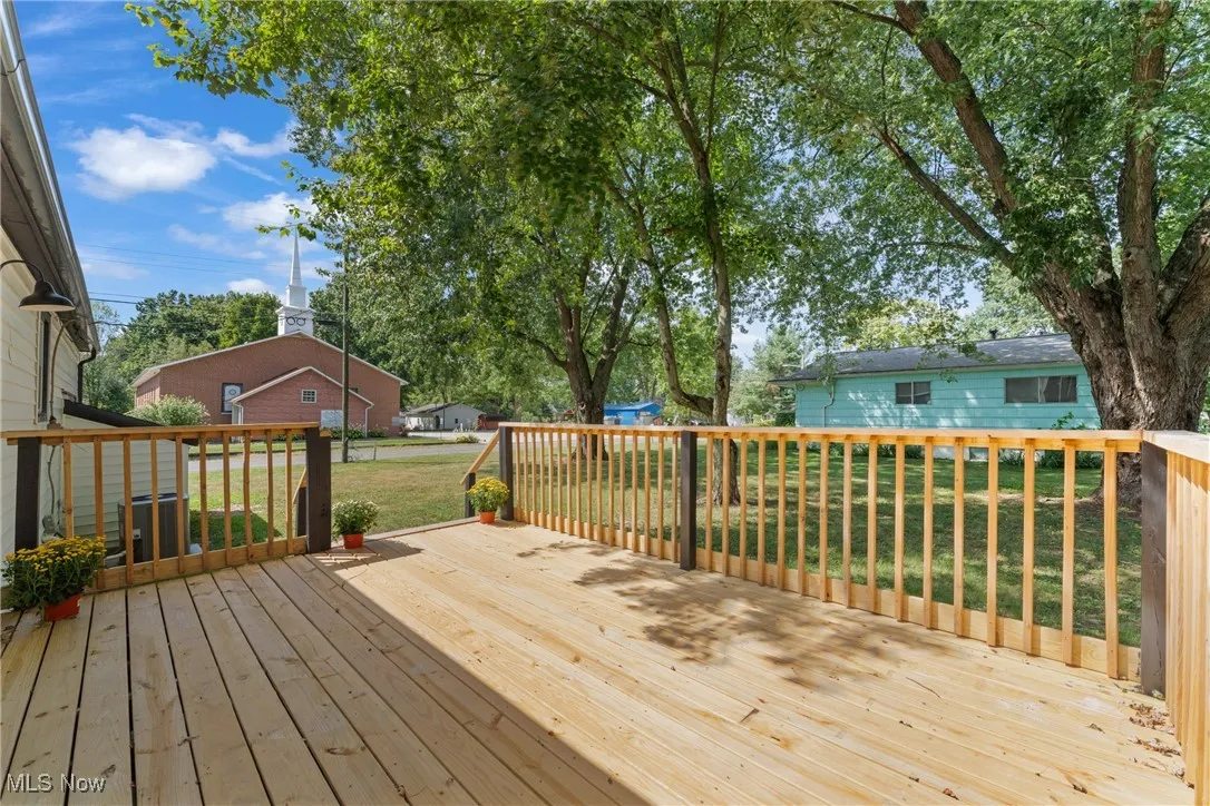 Wooden deck featuring a lawn
