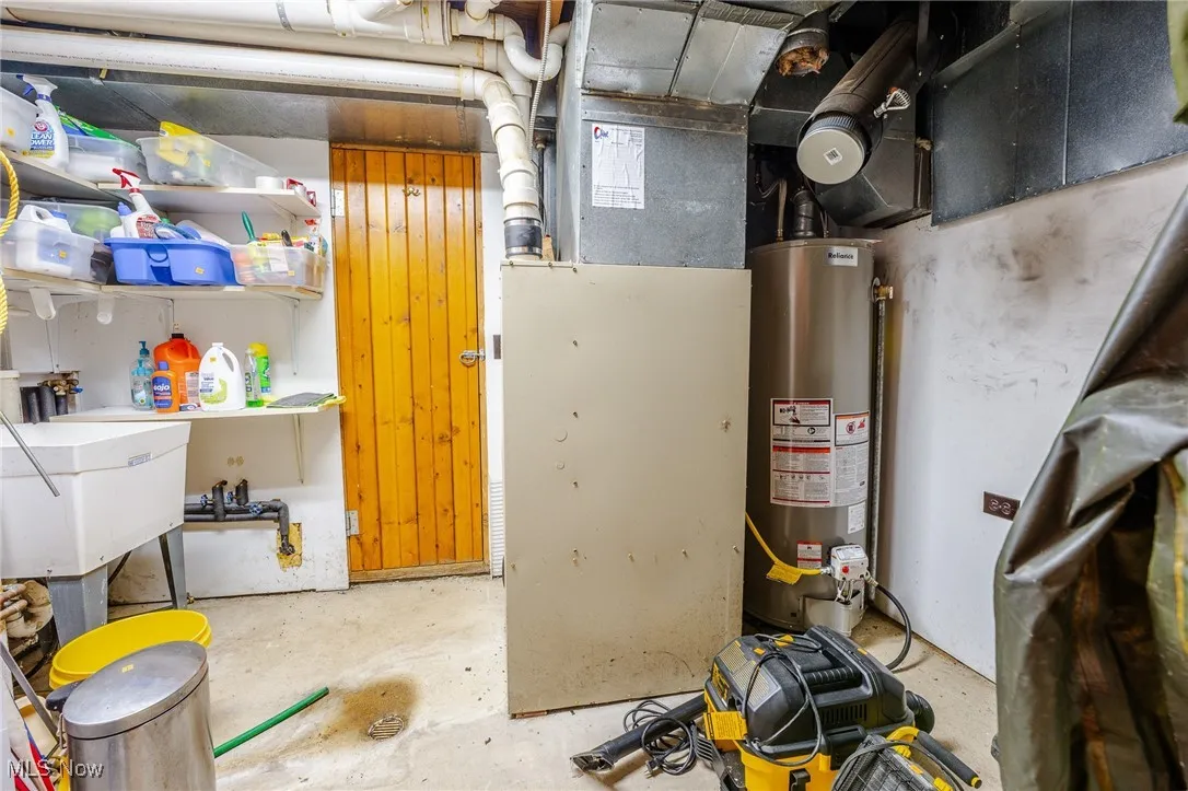 Utility room featuring gas water heater and heating unit