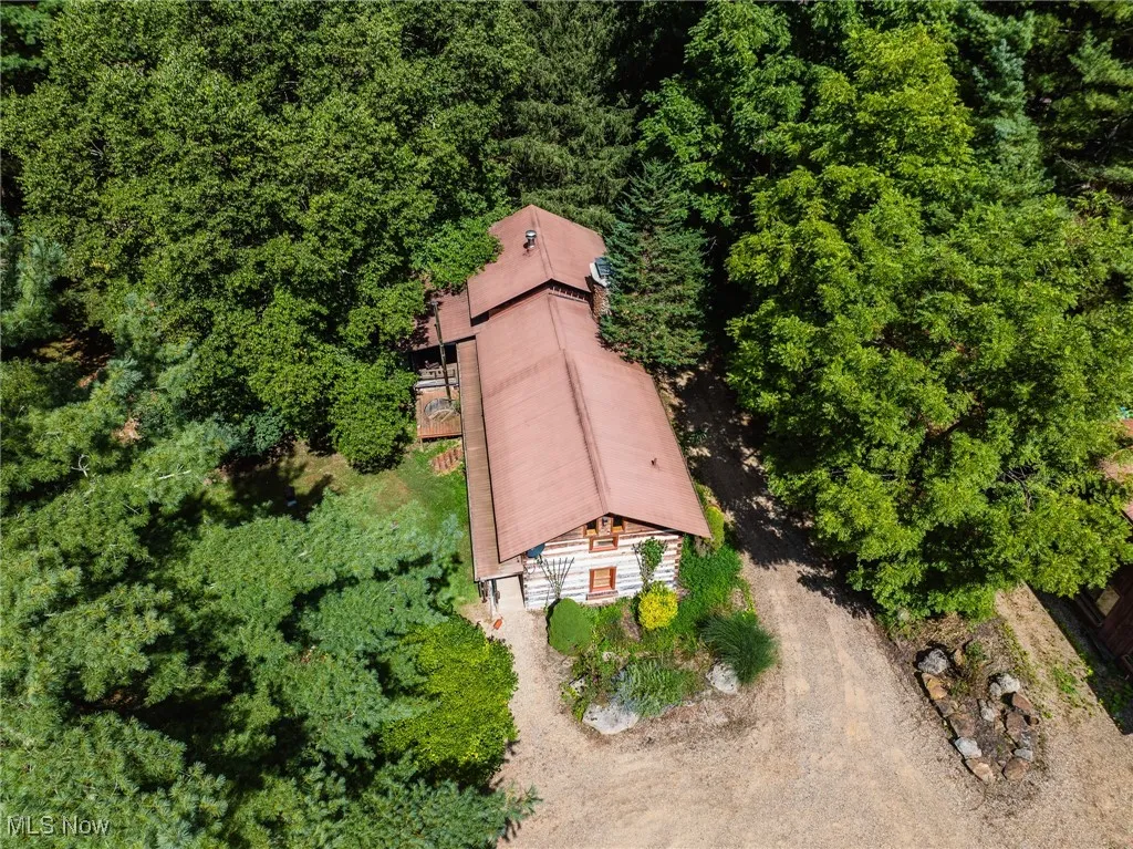 View from above of property featuring a heavily wooded area