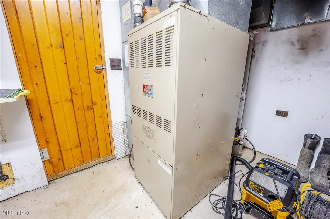 Utility room featuring heating unit