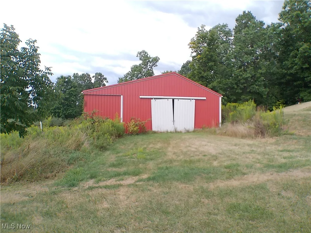 View of pole building featuring a lawn