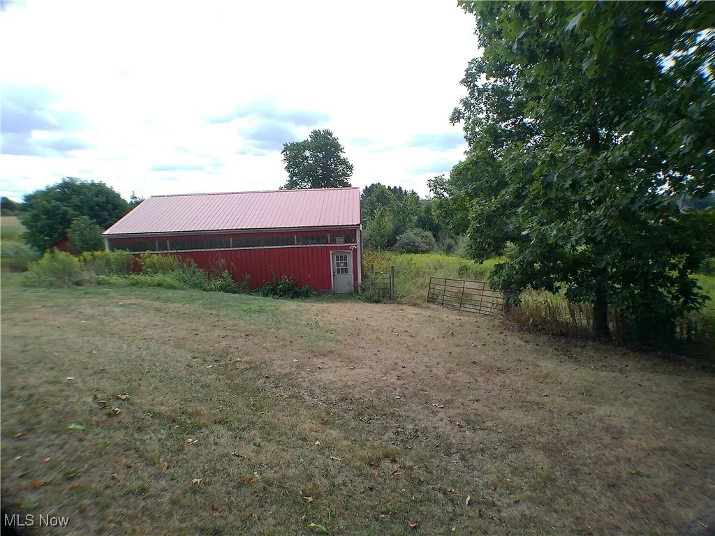 View of yard with an outbuilding and a pole building