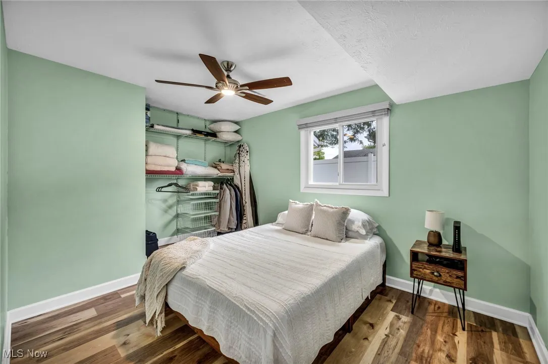 Bedroom featuring dark wood finished floors and a ceiling fan