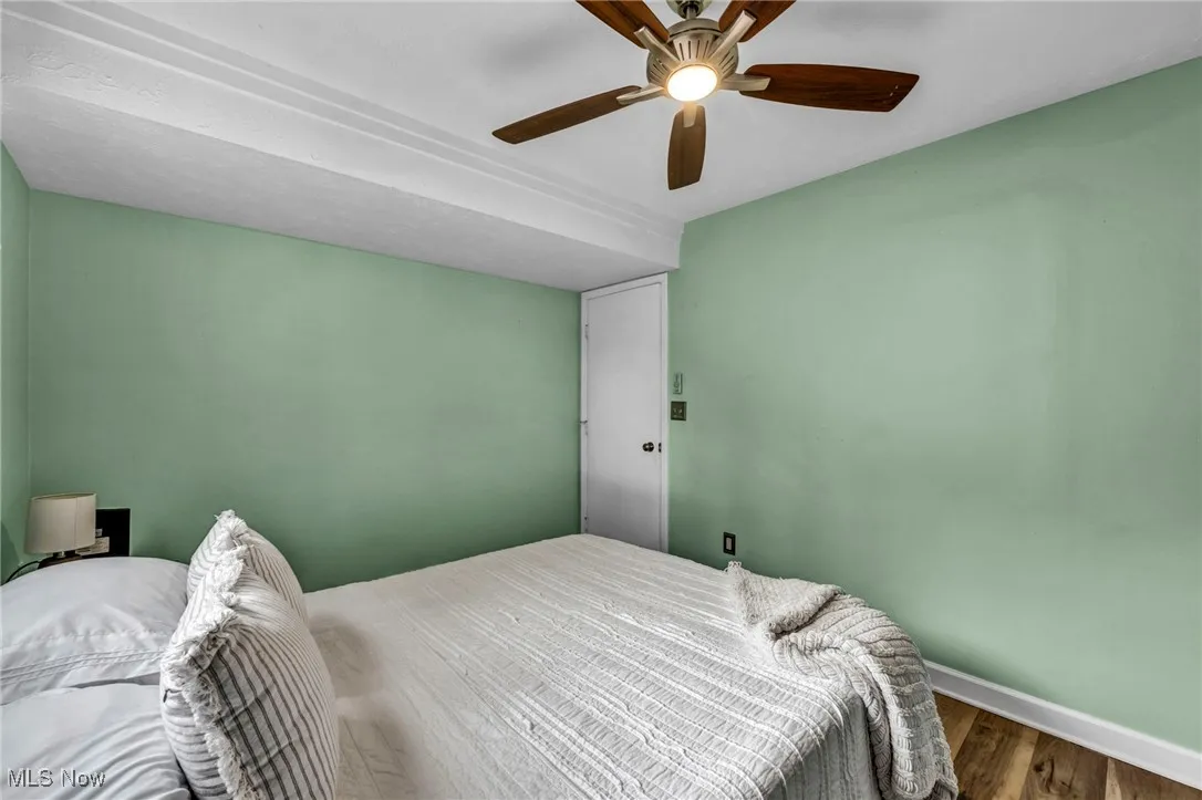 Bedroom with wood finished floors and ceiling fan