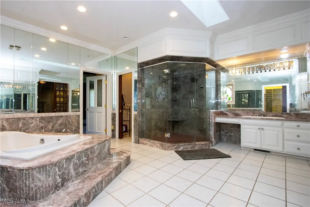 primary bathroom with  tub, shower, sauna and excercise room