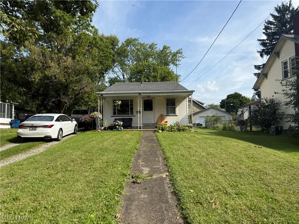 Bungalow-style home featuring a porch and a front lawn