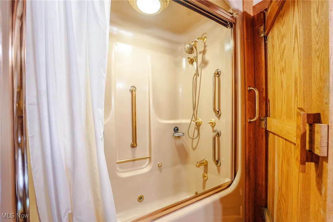 Full bath featuring shower / bath combination with curtain