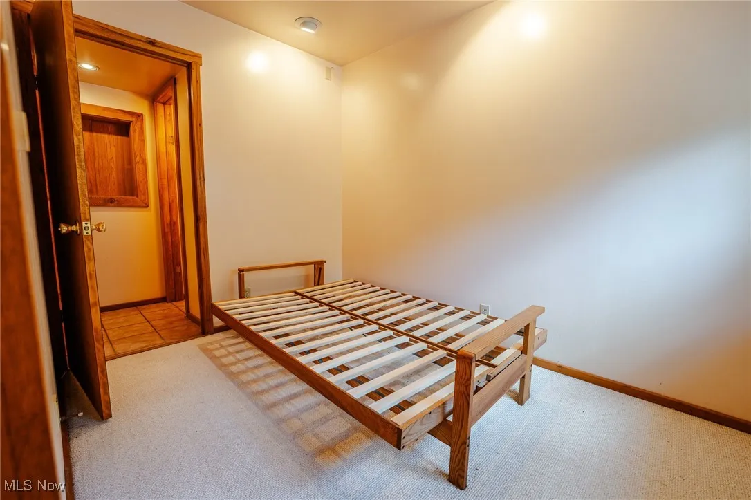 Bedroom featuring light colored carpet and light tile patterned floors