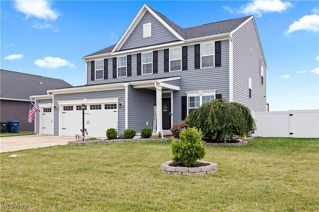 View of front of property with driveway and an attached 3 car garage