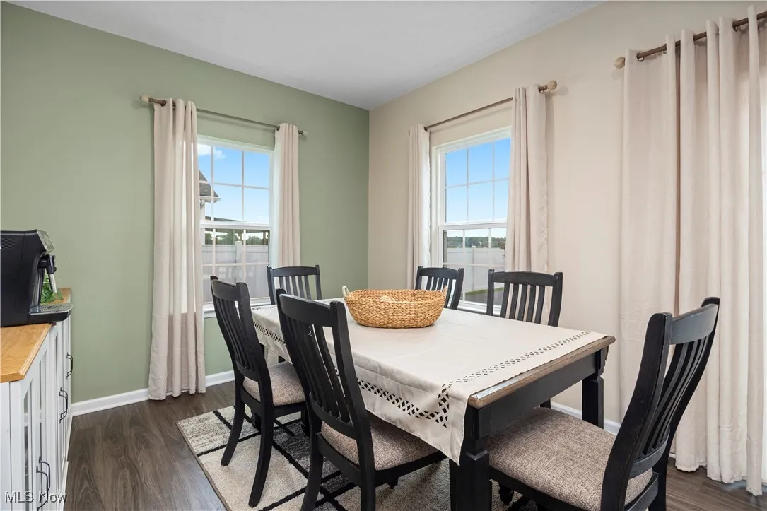 Dining area with dark wood-style floors