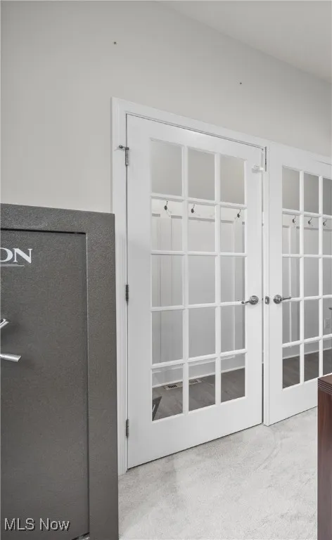 Detailed view of carpet floors and french doors