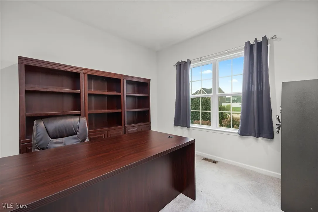 Front office with light colored carpet and baseboards