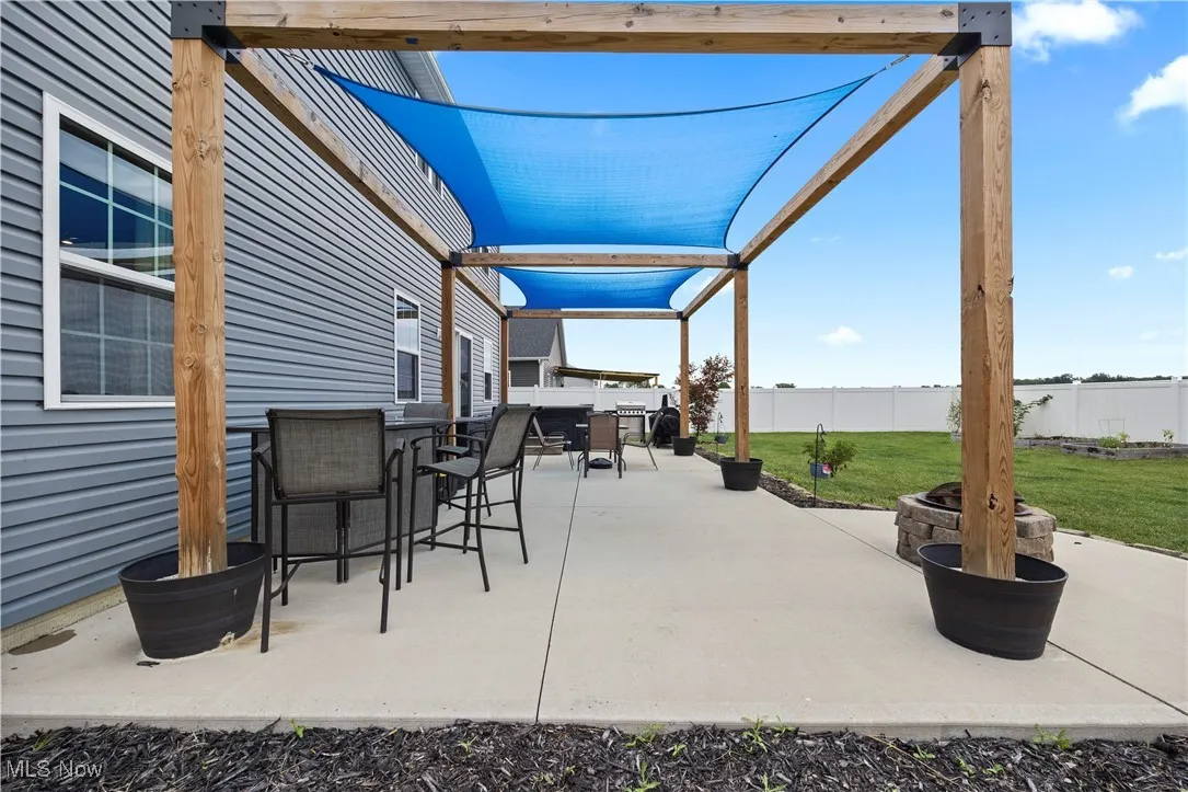 View of patio / terrace with a pergola and an outdoor fire pit
