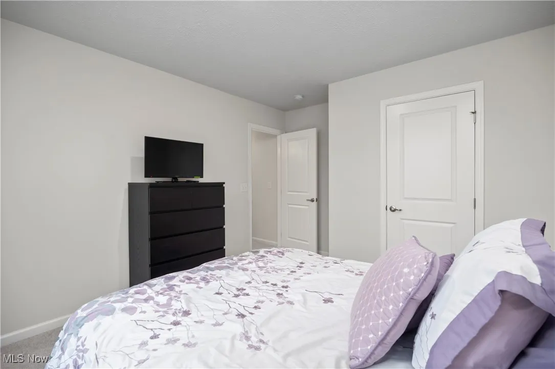 Carpeted bedroom with baseboards