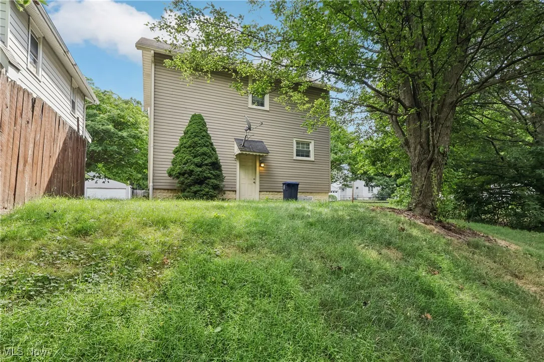 Rear view of house with a back yard