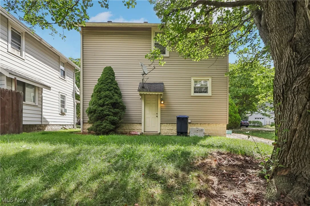 Rear view of house with a back yard