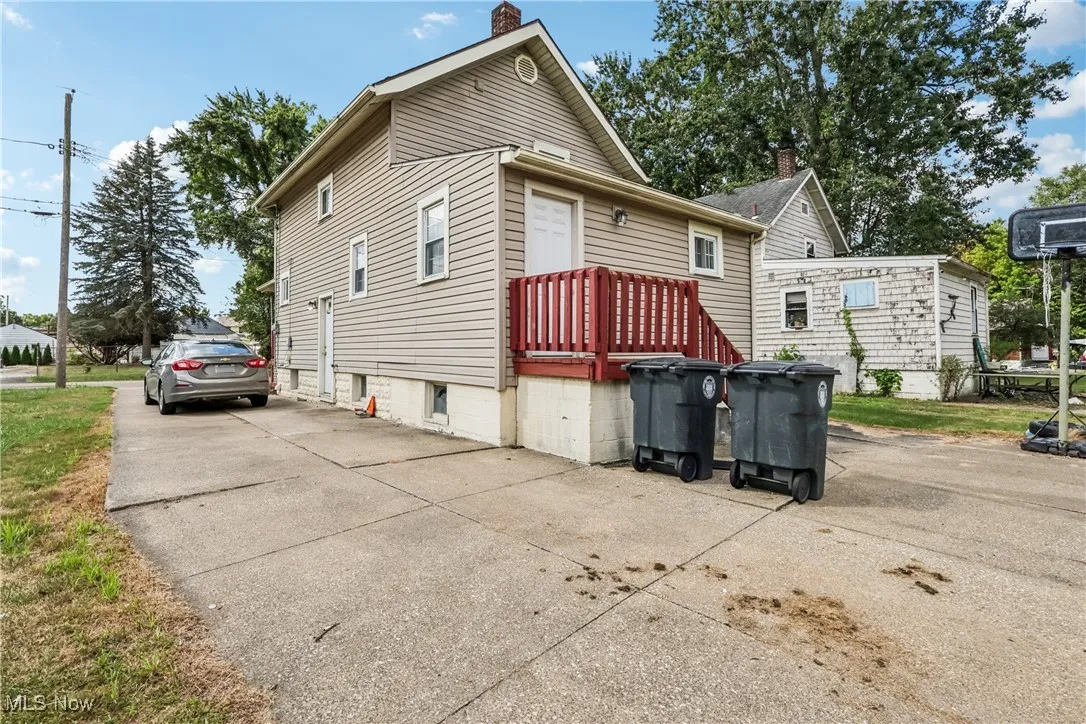 Back of house featuring back door entry and a concrete driveway