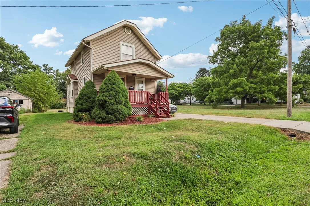View of front of house with a covered porch and a front yard
