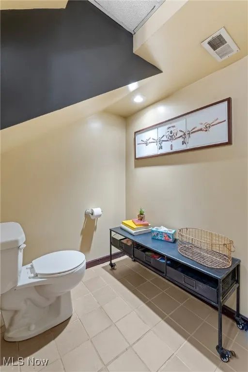Half bath featuring light tile patterned floors and recessed lighting