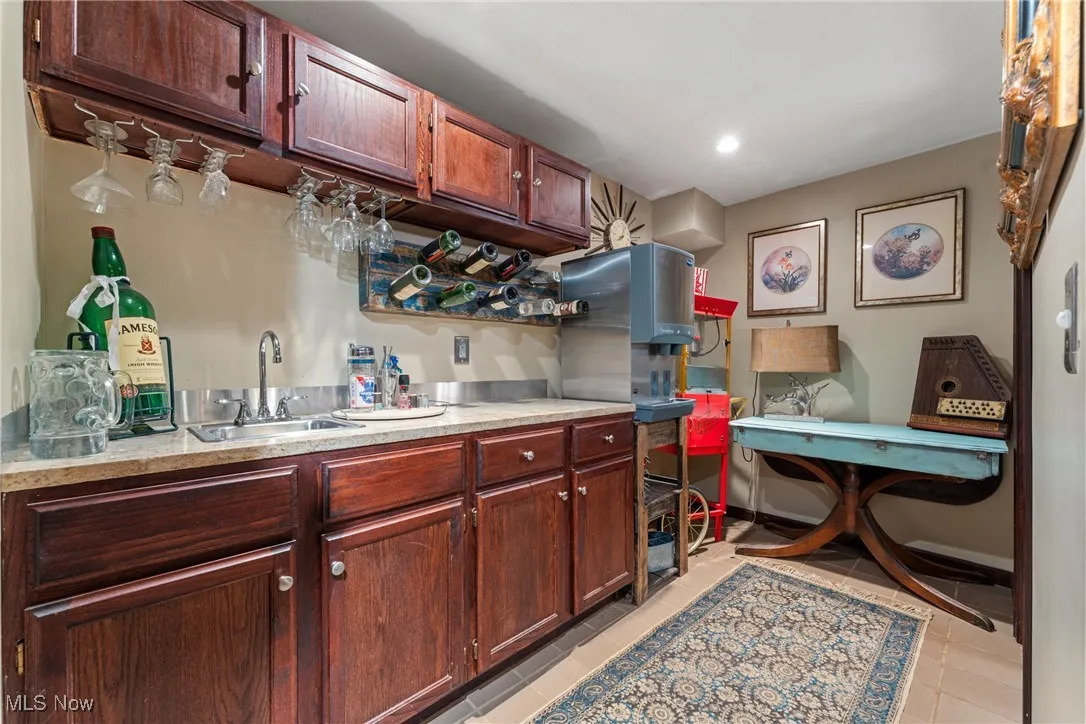 Kitchen with light countertops, light tile patterned floors, and recessed lighting
