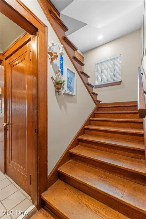 Staircase featuring tile patterned flooring and recessed lighting