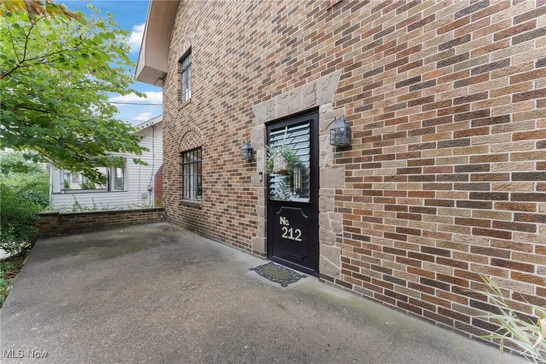 View of exterior entry featuring brick siding