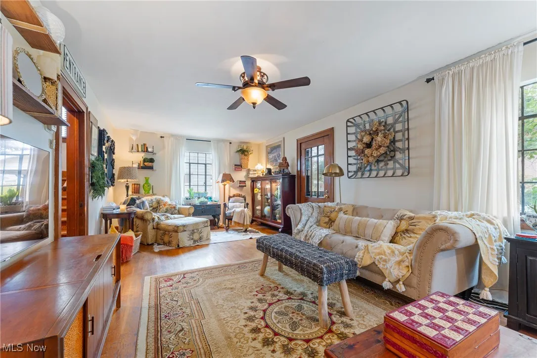 Living room featuring healthy amount of natural light, light wood-style flooring, and ceiling fan