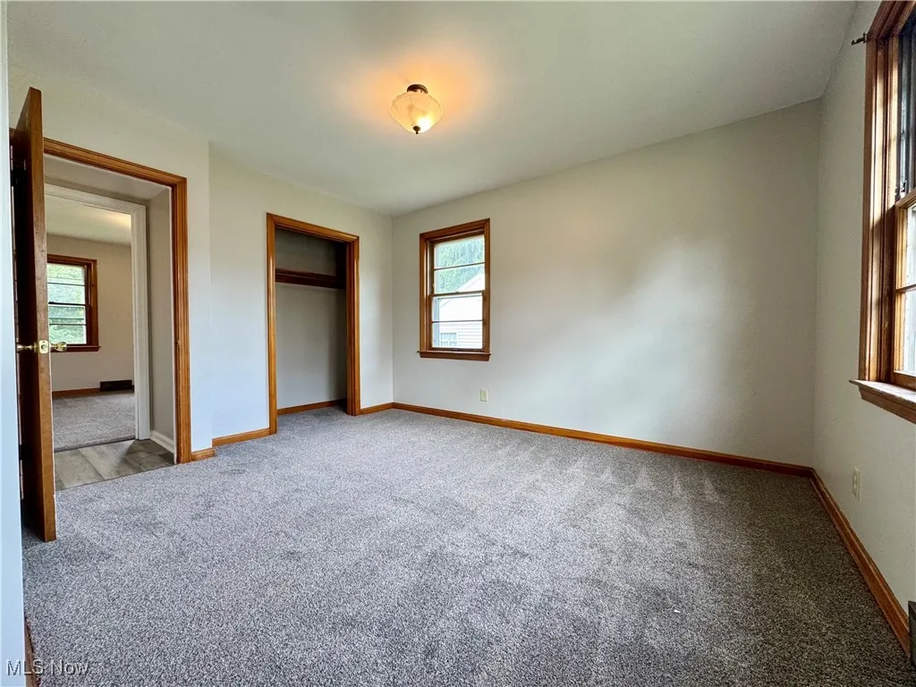 Unfurnished bedroom with carpet floors and a closet