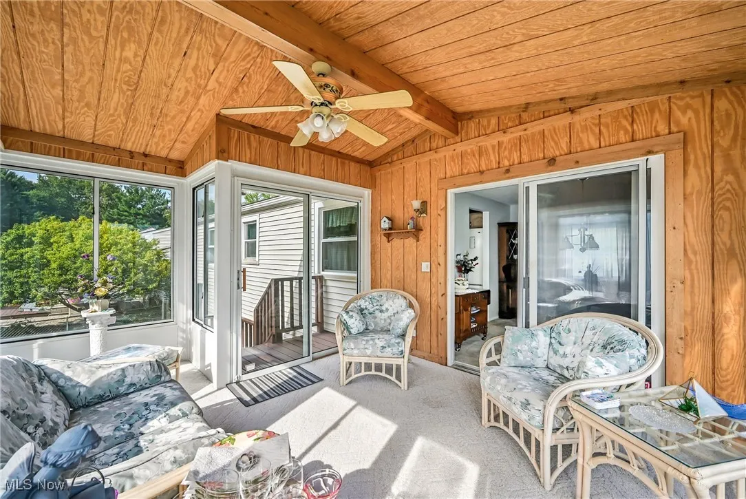 Sunroom featuring a ceiling fan and outdoor lounge area