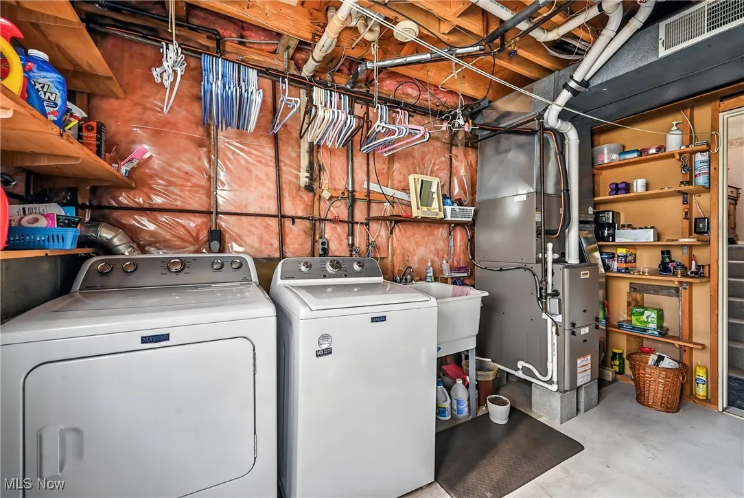 Laundry area featuring heating unit and washing machine and clothes dryer